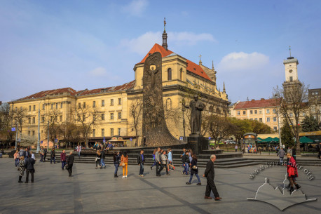 General view of the square with Taras Shevchenko monument in its center. On the background, former Jesuit church and collegium buildings