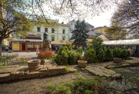 Pl. Pidkovy. Ivan Pidkova monument. On the foreground, the traced foundations of old Holy Spirit Hospital building. Green building on the background – vul. Teatralna, 11