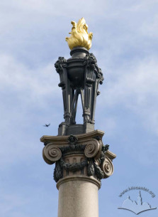 The flaming torch on top of the column
