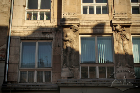 Vul. Halytska, 21. A detail of the western facade. 2nd floor windows and Zygmunt Kurczynski's reliefs