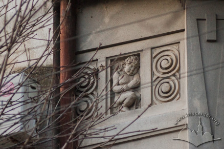 Vul. Vyshenskoho, 13. A bass relief with a putti placed by a balcony on the second floor